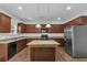 Spacious kitchen featuring dark cabinets, granite countertops, and a center island at 1099 Sandy Bank Ct, Auburn, GA 30011