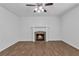 Cozy living room featuring a fireplace with stone surround and wood-look flooring at 1099 Sandy Bank Ct, Auburn, GA 30011