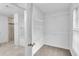 Walk-in closet featuring shelving, connecting to the bathroom and bedroom at 1099 Sandy Bank Ct, Auburn, GA 30011
