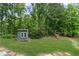 The backyard features a shed with a playset in a private, wooded setting at 1784 Brookstone Nw Ct, Acworth, GA 30101