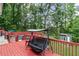 Back deck with a swing overlooking the pool and a lush backyard at 1784 Brookstone Nw Ct, Acworth, GA 30101