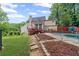 Exterior backyard view of home featuring a deck, pool area, and lawn at 1784 Brookstone Nw Ct, Acworth, GA 30101