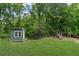 The yard features a shed with a playset in a private, wooded setting at 1784 Brookstone Nw Ct, Acworth, GA 30101