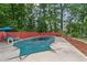 Relax by the covered pool in this backyard retreat with mature trees for shade and privacy at 1784 Brookstone Nw Ct, Acworth, GA 30101