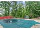 The backyard includes a covered pool, shed, and playset, offering plenty of room to play at 1784 Brookstone Nw Ct, Acworth, GA 30101