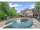 The backyard features a covered pool, patio, shed, playset and lush lawn at 1784 Brookstone Nw Ct, Acworth, GA 30101