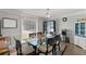 Formal dining room with ample natural light, chandelier, and a glass table at 1784 Brookstone Nw Ct, Acworth, GA 30101