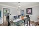 Elegant dining room with glass table, modern lighting, and neutral wall color at 1784 Brookstone Nw Ct, Acworth, GA 30101