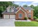 Charming brick two-story home with a two-car garage and well-manicured lawn at 1784 Brookstone Nw Ct, Acworth, GA 30101