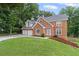 Charming brick two-story home with a two-car garage and a playset on the lawn at 1784 Brookstone Nw Ct, Acworth, GA 30101
