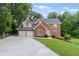Charming brick two-story home with a two-car garage and a well-maintained lawn at 1784 Brookstone Nw Ct, Acworth, GA 30101
