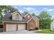 Charming brick two-story home with a two-car garage and a well-manicured lawn at 1784 Brookstone Nw Ct, Acworth, GA 30101