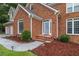 Inviting brick home entrance with a manicured lawn and decorative landscaping at 1784 Brookstone Nw Ct, Acworth, GA 30101