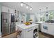 Bright kitchen with island, stainless steel appliances, and modern lighting at 1784 Brookstone Nw Ct, Acworth, GA 30101