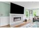 Cozy living room featuring a modern fireplace and large windows at 1784 Brookstone Nw Ct, Acworth, GA 30101