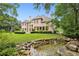 Large estate home with pristine lawn and decorative water feature at 2503 Regency Lake Dr, Marietta, GA 30062