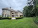 Expansive backyard with a lush lawn and well-maintained landscaping surrounding a tan two-story home at 2503 Regency Lake Dr, Marietta, GA 30062