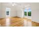 Well-lit bedroom featuring hardwood floors, a ceiling fan, and two windows at 2503 Regency Lake Dr, Marietta, GA 30062