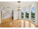 Bright dining room with arch windows, chandelier, hardwood floors and staircase with wood entry door at 2503 Regency Lake Dr, Marietta, GA 30062