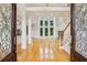 Grand foyer view with detailed glass doors, open floor plan, soaring windows and gleaming hardwood floors at 2503 Regency Lake Dr, Marietta, GA 30062