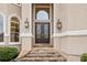 Elegant front entrance with double doors, stone steps, and decorative exterior lighting at 2503 Regency Lake Dr, Marietta, GA 30062