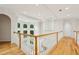 Bright hallway with hardwood floors, white railing, arched doorways, and multiple windows offering natural light at 2503 Regency Lake Dr, Marietta, GA 30062