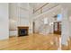 Spacious open-concept living room boasts a fireplace, hardwood floors, and soaring ceilings with a charming chandelier at 2503 Regency Lake Dr, Marietta, GA 30062