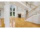 Bright, open living room featuring a cozy fireplace, a soaring ceiling, and large windows with natural light at 2503 Regency Lake Dr, Marietta, GA 30062