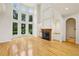 Bright living room featuring a fireplace and soaring windows that provide ample natural light and a view of the landscaped yard at 2503 Regency Lake Dr, Marietta, GA 30062