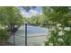 Community tennis court with a well-maintained playing surface and surrounding greenery at 2503 Regency Lake Dr, Marietta, GA 30062