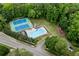 Aerial view of the community pool, tennis courts, and playground area surrounded by mature trees at 3915 Woolbridge Way, Marietta, GA 30062