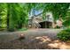 Spacious backyard with a fire pit and a two-story deck and patio under mature shade trees at 3915 Woolbridge Way, Marietta, GA 30062