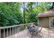 Enjoy outdoor dining on this wooden deck with views of the surrounding lush greenery and natural landscape at 3915 Woolbridge Way, Marietta, GA 30062