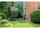 Landscaped backyard featuring flowerbeds, shrubs, and a well-maintained lawn at 3915 Woolbridge Way, Marietta, GA 30062