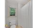 Clean bathroom featuring a toilet and a white shower curtain over a tub at 3915 Woolbridge Way, Marietta, GA 30062