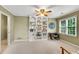 Well-lit bedroom featuring a built-in bookcase and a cozy chair by the window at 3915 Woolbridge Way, Marietta, GA 30062
