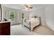 Bedroom boasts a ceiling fan, plush carpeting, and plenty of natural light at 3915 Woolbridge Way, Marietta, GA 30062