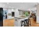 Bright kitchen featuring an island with granite countertop and bar seating open to the living room with a fireplace at 3915 Woolbridge Way, Marietta, GA 30062