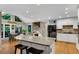 Bright kitchen with a granite-topped island, black appliances, and an adjacent dining area at 3915 Woolbridge Way, Marietta, GA 30062
