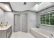 Bright main bathroom with skylight, soaking tub, separate shower, and double vanity at 3915 Woolbridge Way, Marietta, GA 30062