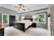 Spacious main bedroom boasts a ceiling fan, two windows, and sleek dark furniture at 3915 Woolbridge Way, Marietta, GA 30062