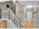 Bright hallway and staircase showcasing neutral decor, hardwood floors, and elegant white railing at 3915 Woolbridge Way, Marietta, GA 30062