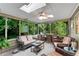 Relax in this sunroom with screened windows, a ceiling fan, and comfortable furniture to enjoy your morning coffee at 3915 Woolbridge Way, Marietta, GA 30062
