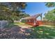 A spacious backyard features green grass, mature trees, and a fenced-in area with a cozy back porch at 647 New England Way, Lawrenceville, GA 30046