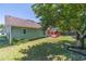 Large backyard with lush green grass, mature trees, and a fenced-in area with a cozy back porch at 647 New England Way, Lawrenceville, GA 30046