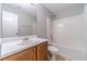 Bathroom featuring vanity with a large mirror, toilet, and shower with a white tub at 647 New England Way, Lawrenceville, GA 30046