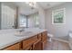 Bathroom featuring a large mirror, wooden cabinets and bright light at 647 New England Way, Lawrenceville, GA 30046