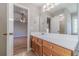 Bathroom with hardwood floors, wooden cabinets, and access to the bedroom at 647 New England Way, Lawrenceville, GA 30046