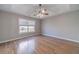Spacious bedroom with modern ceiling fan and large windows with bright natural light at 647 New England Way, Lawrenceville, GA 30046