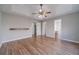 Open bedroom with hardwood floors, neutral paint, and access to bathroom at 647 New England Way, Lawrenceville, GA 30046